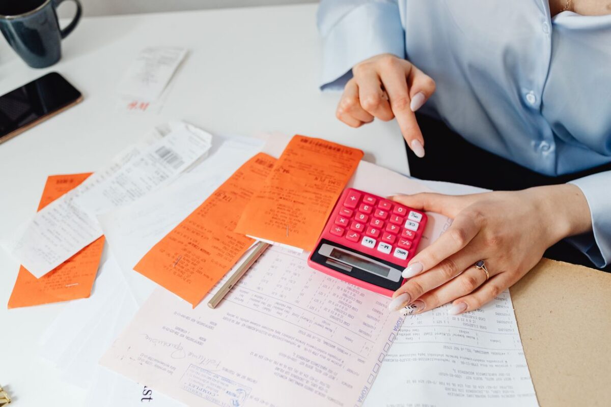 A woman computing expenses with a calculator